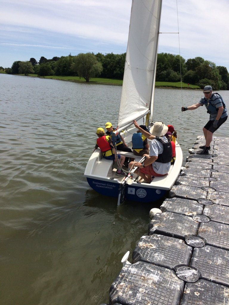 Photo of Ash on the pontoon assisting Paul and some Brownies as they set sail on Somerspirit 