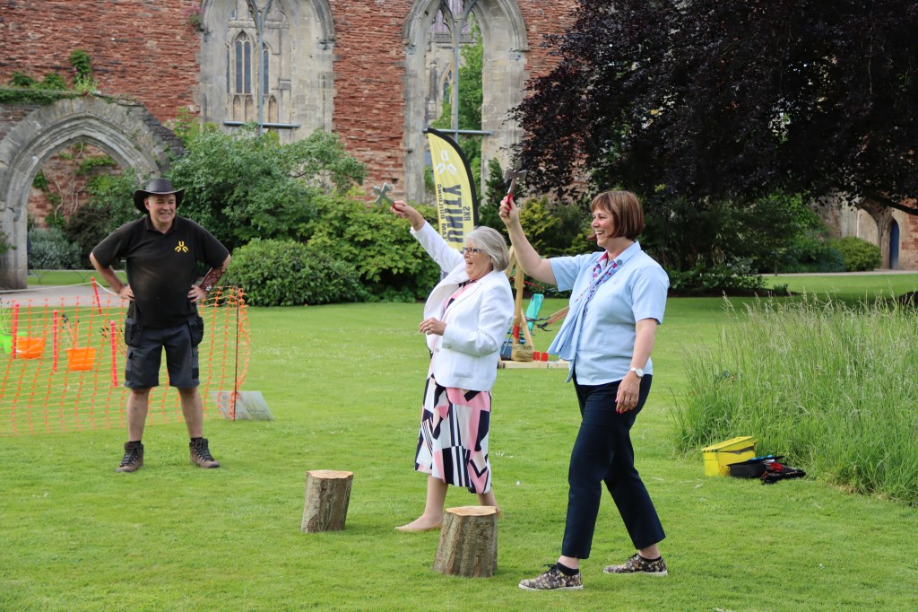 The Girlguiding Somerset County Commissioner Beverley Osborne and the Girlguiding Somerset County President Margaret Maltby try out Axe Throwing
