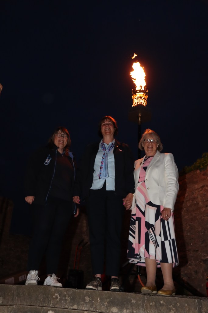 The Girlguiding Somerset County Commissioner Beverley Osborne, Assistant County Commissioner Ruth Forbes and the Girlguiding Somerset County President Margaret Maltby with the beacon