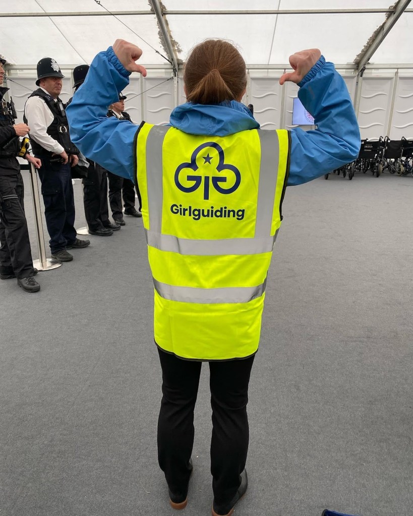 Kelly facing away wearing her Girlguiding branded hi-vis jacket