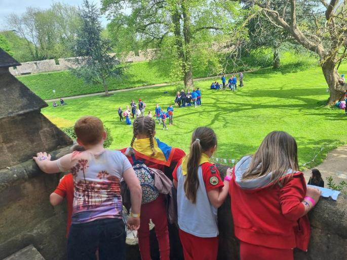 Rainbows overlook activities on the lawn from a vantage point over the Bishops Palace gardens in Wells