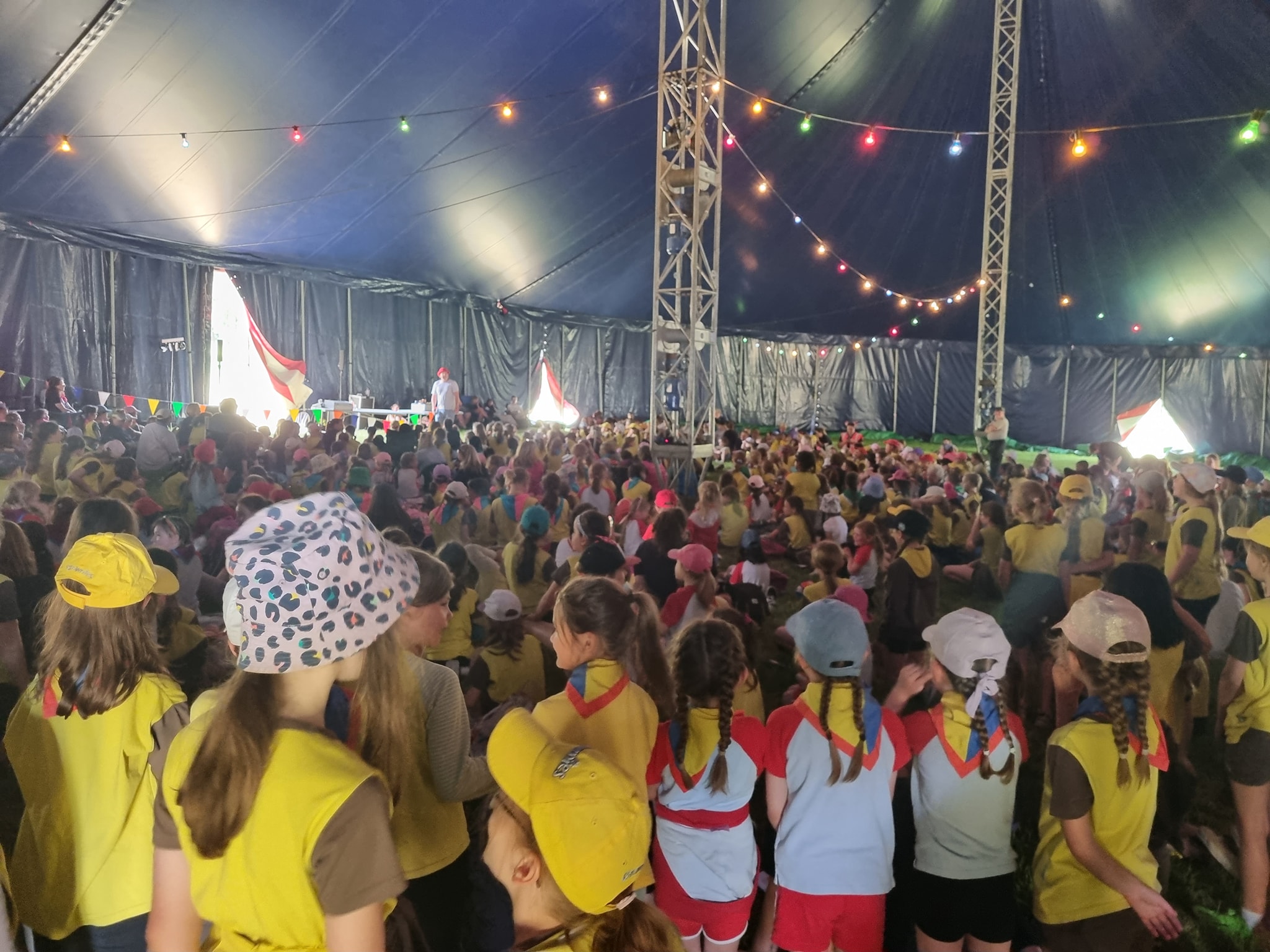 Hundreds of Rainbows and Brownies watching a magic show inside the Big Top