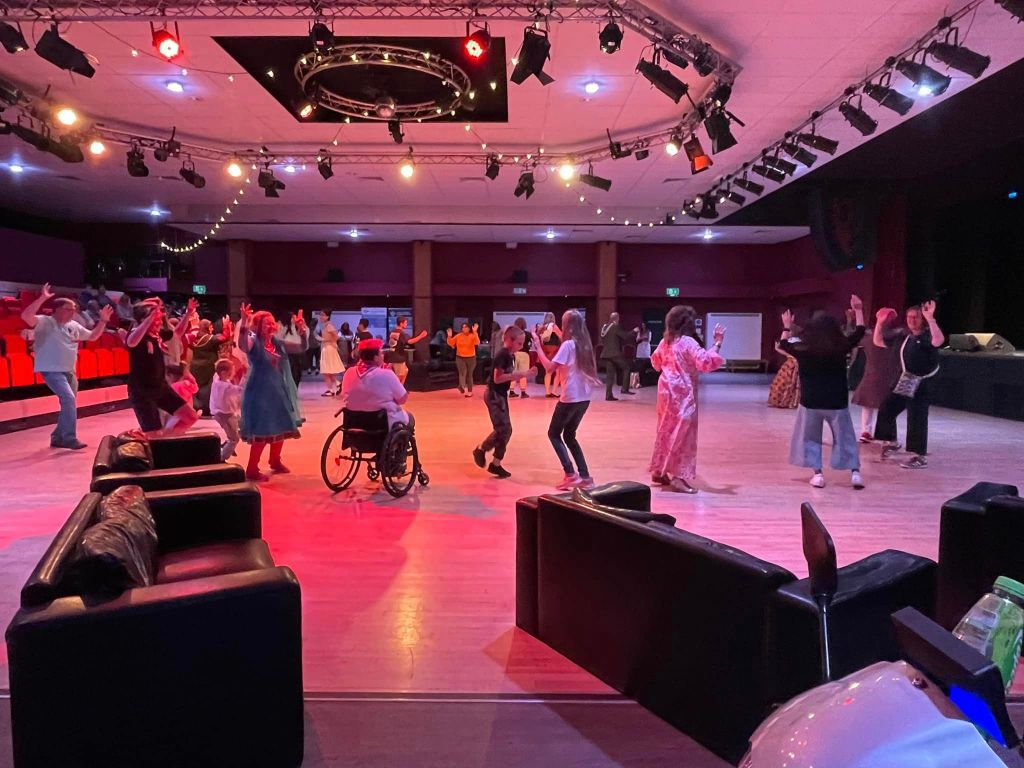 Photo of Girlguiding leaders and others taking part in a Bhangra dance lesson