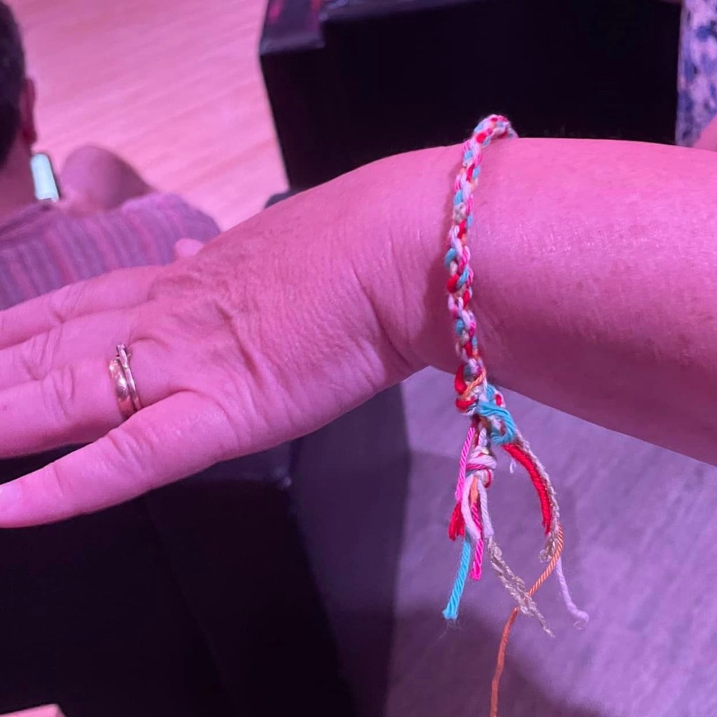 Adult shows off the friendship bracelet she's been given at the Girlguiding Yeovil stall