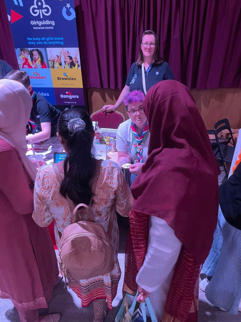 Girlguiding volunteers share an activity with a girl and her family