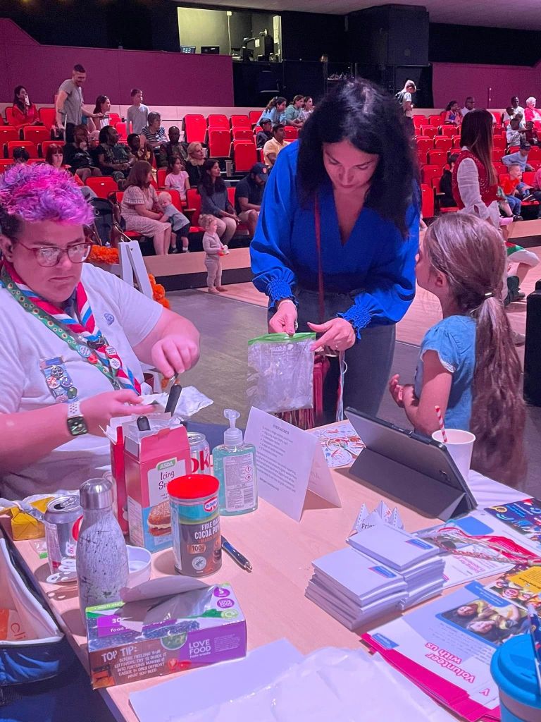 A girl and her mum make 'armpit fudge' with a girlguiding volunteer