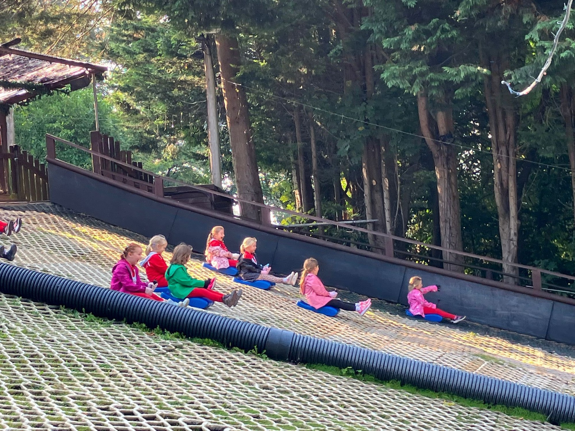 Girls enjoying sledging at Mendip activity centre