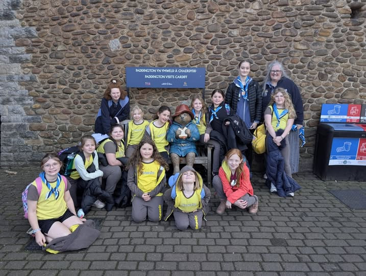 Brownies and Guides pose for a photo with Paddington Bear on their Cityscape Adventure
